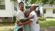 FROM LEFT TO RIGHT: HOST DAVID BROMSTAD POSE FOR A PICTURE WITH  LOTTERY WINNERS DEBORAH AND JOHN TEAGUE OUTSIDE OF HOUSE 3, BOTTLEBRUSH BAY
