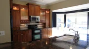 Although fully updated, this dark kitchen is a stark contrast to the sunny Tampa, Florida outdoors, visible through the sliding doors to the deck, as seen on HGTV.s House Hunters.