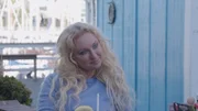 Natalie smiles while listening to Josh in a restaurant