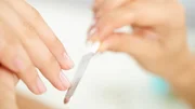 Hand of woman getting manicure