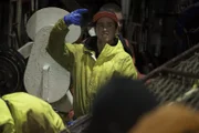 Kyle Dyerly, deckhand on the Time Bandit, gives Captain Johnathan Hillstrand the crab count.