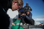 Dave Reichert and Trent Ellis work to capture Spenser McCleskey in gold-panning-action.
