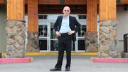 Host Anthony Melchiorri poses in front of the Anchorage Lofts Hotel in Anchorage, Alaska.