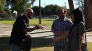 Jackson Galaxy and Chris talking with a woman in a park.