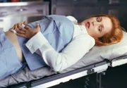 Agent Dana Scully (Gillian Anderson) undergoes testing regarding her pregnancy.