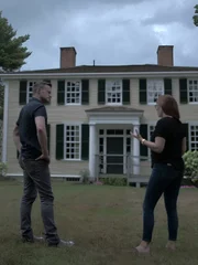 Paranormal investigators Amy Bruni and Adam Berry in front of the Historic Oliver Estate in Middleborough, Massachusetts.