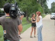 Tia being filmed talking to Lizzy/Elise out front of Rick and Michelle's.