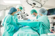 Team of doctors concentrating on a patient during a heart surgery at a hospital