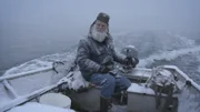 Gary Muelberger on his skiff that is covered with recent snow fall.