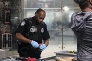 Officer Keith White inspects an item from a passengers luggage. (National Geographic/Lucky 8 TV)
