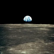 This view from the Apollo 11 spacecraft shows Earth rising above the moon's horizon.