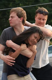 Ward fighting with Maria in a parking lot.