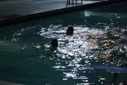 Bryan Nunez and Josh Madson break into the pool at night.