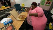 Cynthia at work eats a pizza by herself.