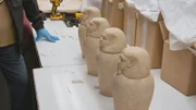 Officer Acevedo opens a crate containing ancient Egyptian canopic jars. (National Geographic)