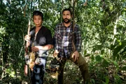 Hazen Audel and Ajjee holding muskets and jungle fowl carcasses from their recent hunt.