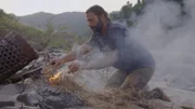 Hazen making a fire using gun powder. (National Geographic/Alex Holden)