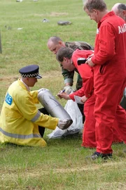 Investigators collecting the parts. Investigators collecting the parts.