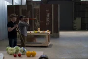 Adam Savage and Tory Belleci practice shooting food at the target.