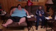 Bri and husband eating on recliners.