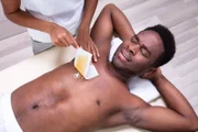 Woman Waxing Man s Chest With Wax Strip