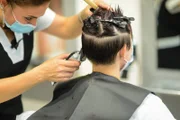 Young attractive female in beauty salon cutting styling and red Milan, Lombardy, Italy