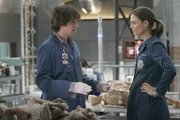 Brennan (Emily Deschanel, R) and Zack (Eric Millegan, L) examine the bodies found in a mysterious spaceship type vessel in the BONES episode "Aliens in the Spaceship" airing Wednesday, Nov. 15 (8:00-9:00 PM ET/PT) on FOX.