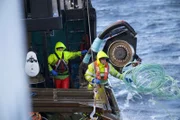 Johnny Mavar, deckhand on the Cornelia Marie, tosses the line out after dropping a pot.