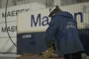 Luke Murkowski, Greenhorn on the Brenna A, preps pots at the dock.