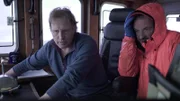 Nick Mavar, deckhand on the Northwestern, with his old friend and Captain, Sig Hansen, review the monitors together in the wheelhouse.