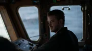 Captain of the Brenna A, Sean Dwyer, at the helm in the wheelhouse.