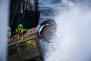 F/V Cornelia Marie battles some large waves as they work to pull crab aboard.