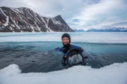 Fotograf und Kamera Assistent Kieran O’Donovan im Wasser entlang der Eiskante