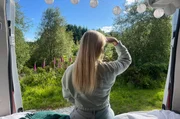 Maike Tschorn blickt begeistert aus ihrem Camper – Schottlands abwechslungsreiche Landschaft ist atemberaubend.