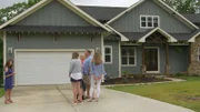 Family meeting realtor in front of house