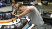 Joey works on Rob's Grad Cake.