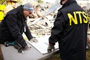 REENACTMENT: Clint Crookshanks (played by Jason Weinberg) and a firefighter navigate through the smouldering wreckage of a Bombardier commercial jet to locate and retrieve the black boxes from the flight, which mysteriously fell from the sky minutes from landing at Buffalo's airport.