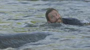 Hazen swimming down a river to catch his boat.