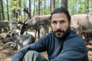 Hazen sitting with reindeers.