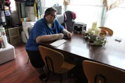 Aaron sitting at kitchen table.