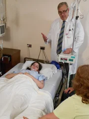 Julie in hospital, James and family beside her. Julie in hospital, James and family beside her.