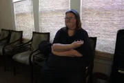 Ashley sits.