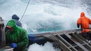 Cold, blue waters meet the crew at the rail of the northwestern.