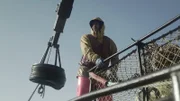 Deckhand on top of pots during the daytime.