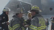Firefighters stand outside the towers. (CNN)
