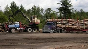Crane loading a logging truck with wood as seen on episode three of American Loggers.
