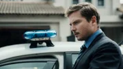 Det Stephanos (TRENT MOFFETT) looks at the blood stains that lead from the garage along the hall.