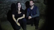 Nick and Katrina in front of stone basement wall.