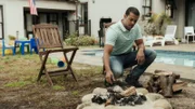 Nathan Residence - Garden: Eric (BLAZE AGULHAS) throws another log on the fire and gives Nathan (CHASE AGULHAS) a beer.