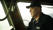 Captain Harley mans the wheel on the Southern Wind.